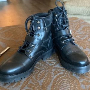 Allsaints black lug sole booties with suede and buckle detail.